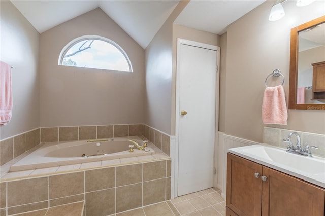 bathroom with vanity, a relaxing tiled tub, tile patterned floors, and lofted ceiling