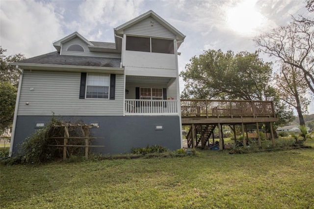 back of house featuring a deck and a yard