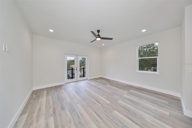 empty room with ceiling fan, french doors, and light hardwood / wood-style floors