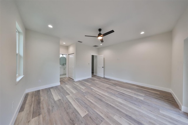 spare room featuring ceiling fan and light hardwood / wood-style flooring