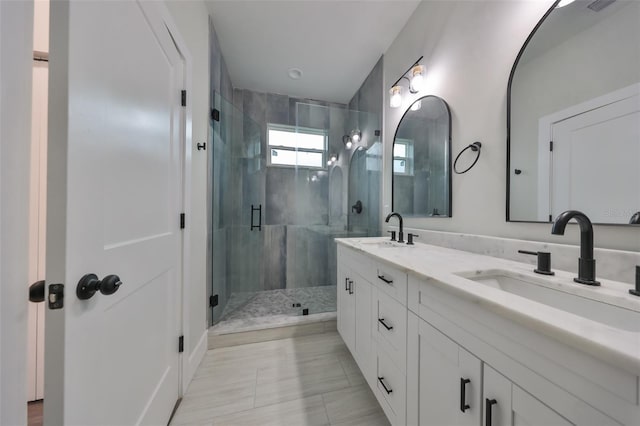 bathroom with tile patterned flooring, an enclosed shower, and vanity