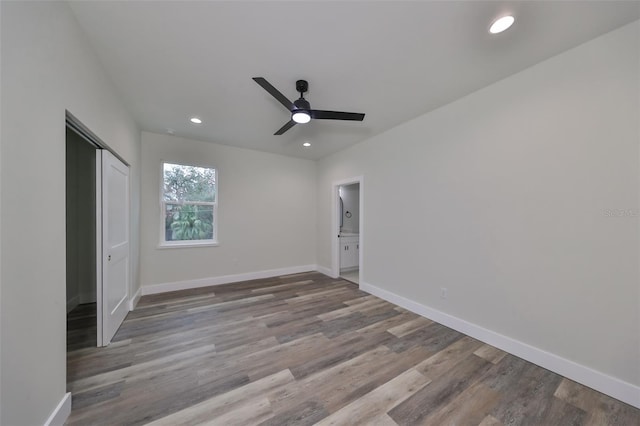 unfurnished bedroom featuring ceiling fan, a closet, and hardwood / wood-style floors