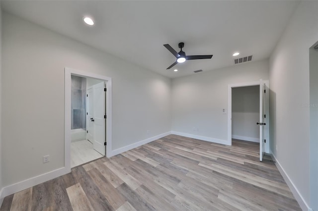 empty room with light wood-type flooring and ceiling fan