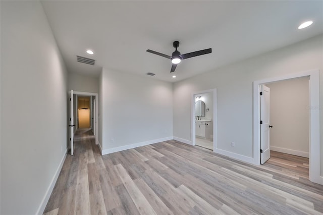 unfurnished bedroom with light wood-type flooring, ceiling fan, and connected bathroom