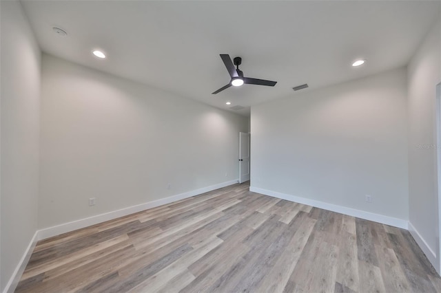 spare room with ceiling fan and light hardwood / wood-style floors