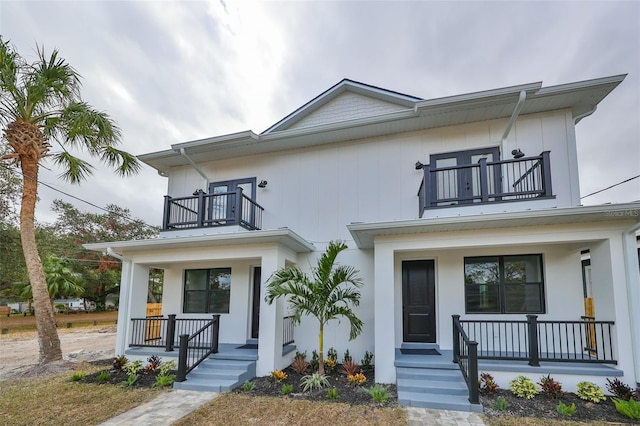 view of front of property with a porch and a balcony