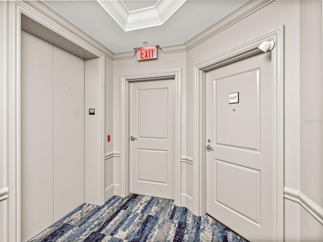 hall with crown molding, carpet floors, and elevator