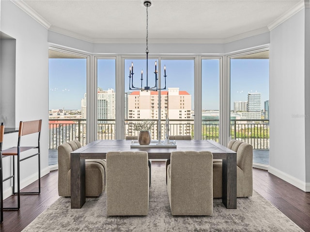 dining area with hardwood / wood-style flooring, a healthy amount of sunlight, and ornamental molding