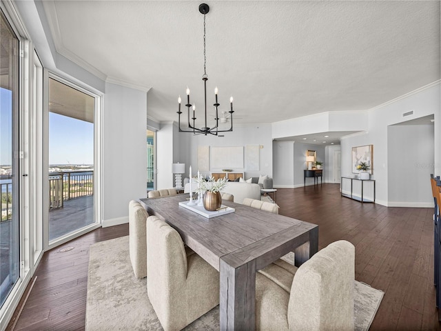 dining area featuring a notable chandelier, a textured ceiling, baseboards, and dark wood-type flooring