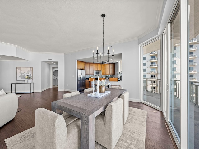 dining space with dark wood-style flooring, an inviting chandelier, ornamental molding, a textured ceiling, and baseboards