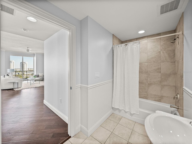 bathroom featuring shower / tub combo with curtain and hardwood / wood-style flooring