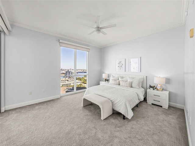 carpeted bedroom featuring ornamental molding and ceiling fan