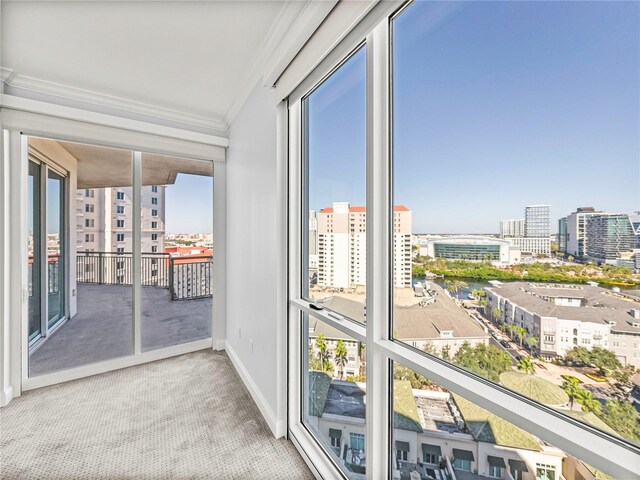 unfurnished sunroom featuring plenty of natural light and a city view