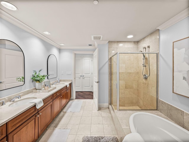 bathroom featuring vanity, ornamental molding, tile patterned floors, and separate shower and tub