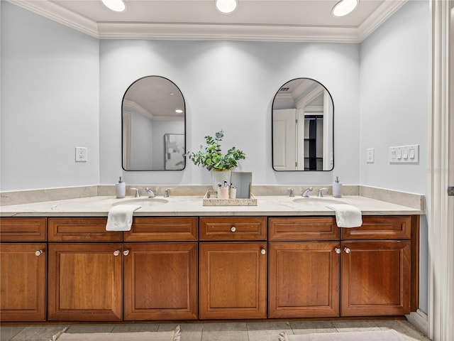 bathroom featuring recessed lighting, crown molding, a sink, and double vanity