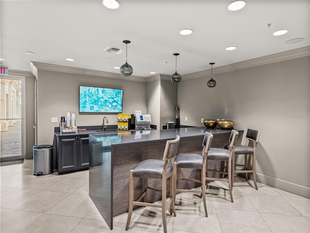 bar with ornamental molding, sink, light tile patterned flooring, and hanging light fixtures