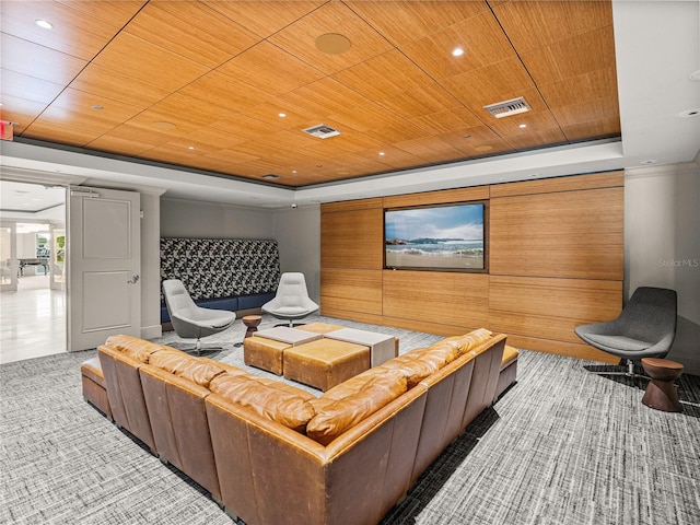 cinema room featuring wooden ceiling, visible vents, and a tray ceiling