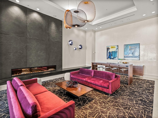 living area with a tray ceiling, marble finish floor, a fireplace, recessed lighting, and a high ceiling