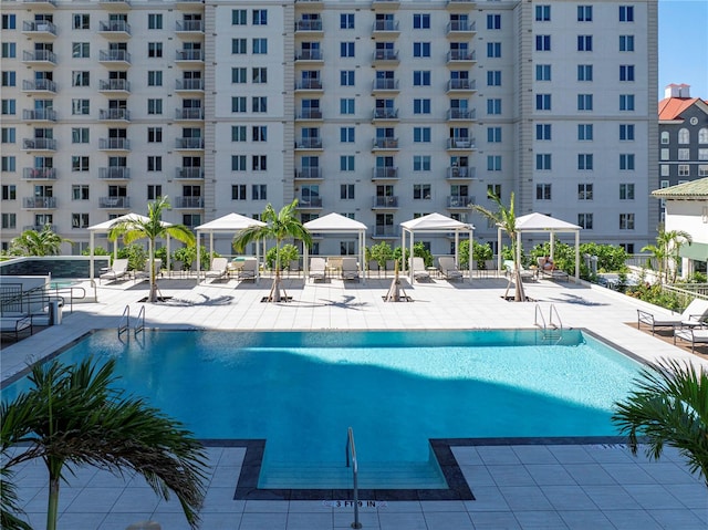 pool with a patio area and a gazebo