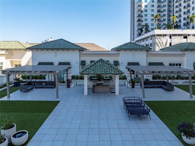 view of community featuring a patio, an outdoor living space, a gazebo, and a lawn