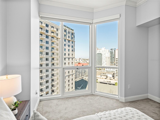 bedroom featuring carpet floors, a view of city, baseboards, and crown molding