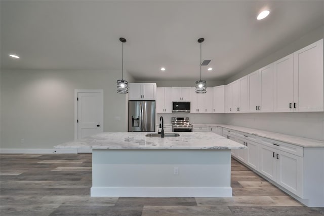 kitchen with sink, white cabinets, an island with sink, and appliances with stainless steel finishes