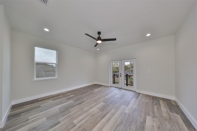 spare room featuring ceiling fan, french doors, and light wood-type flooring