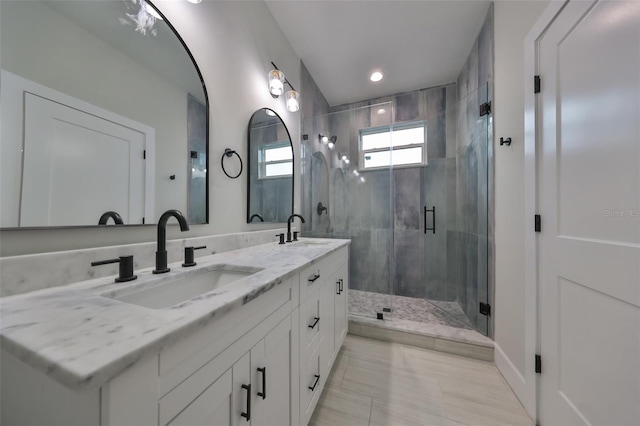 bathroom featuring an enclosed shower and vanity