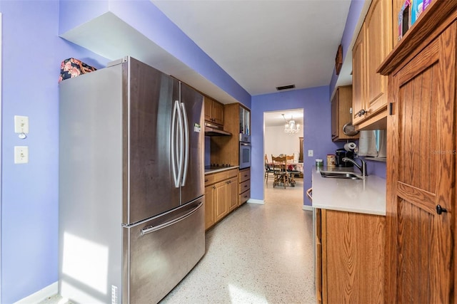 kitchen featuring a chandelier, sink, and stainless steel appliances