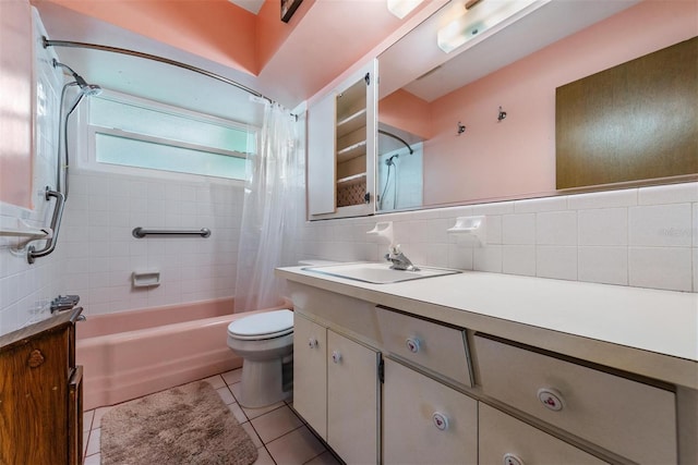 full bathroom featuring shower / bath combo with shower curtain, tile patterned floors, toilet, decorative backsplash, and vanity