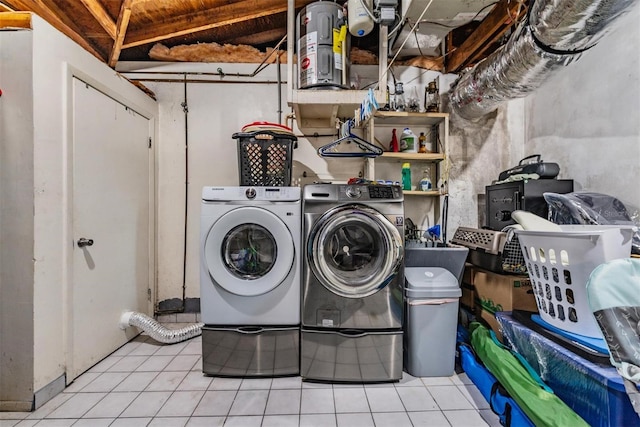 clothes washing area featuring washer and clothes dryer and light tile patterned flooring