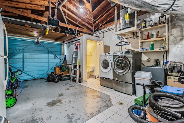 garage with a garage door opener and washing machine and clothes dryer