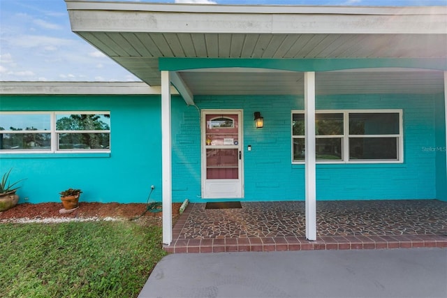 view of exterior entry with covered porch