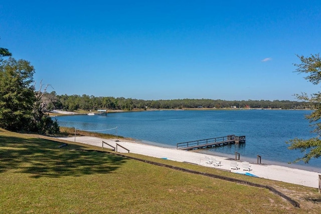 dock area featuring a water view and a lawn