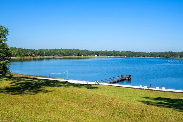 view of dock featuring a yard and a water view