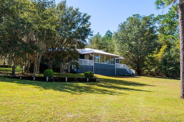 view of yard with a sunroom