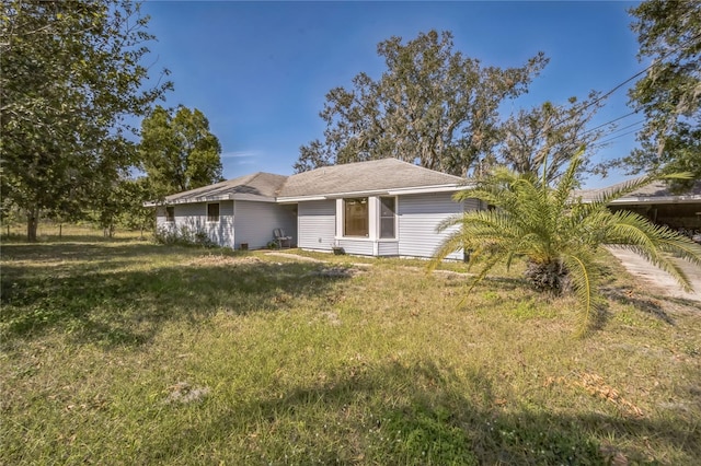 ranch-style home with a front lawn