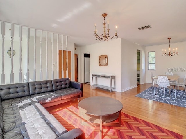 living room with wood-type flooring and a chandelier