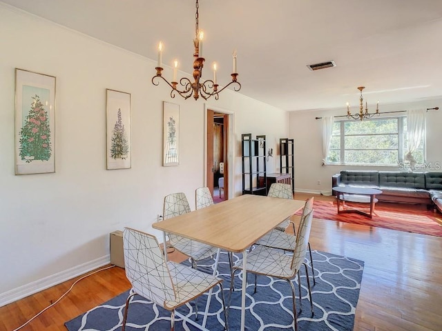 dining space featuring a chandelier and hardwood / wood-style floors