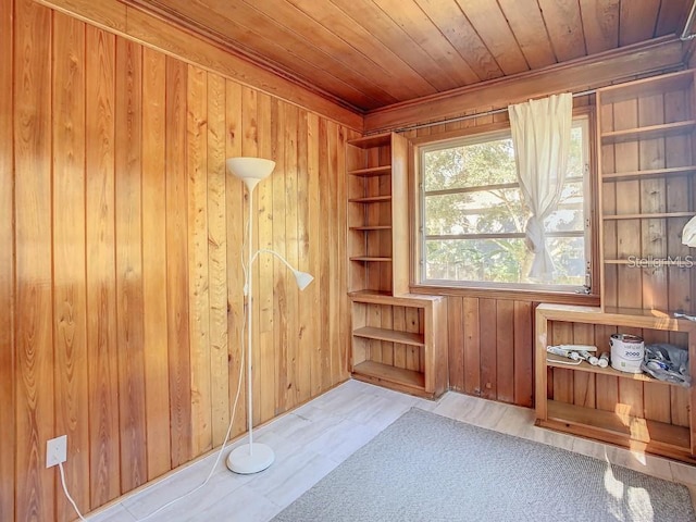 interior space with built in shelves, wood ceiling, and wooden walls