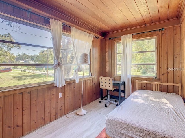 bedroom with ornamental molding, wood walls, and wood ceiling