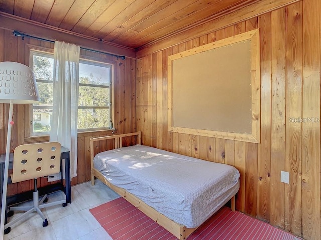 bedroom featuring wooden ceiling and wood walls