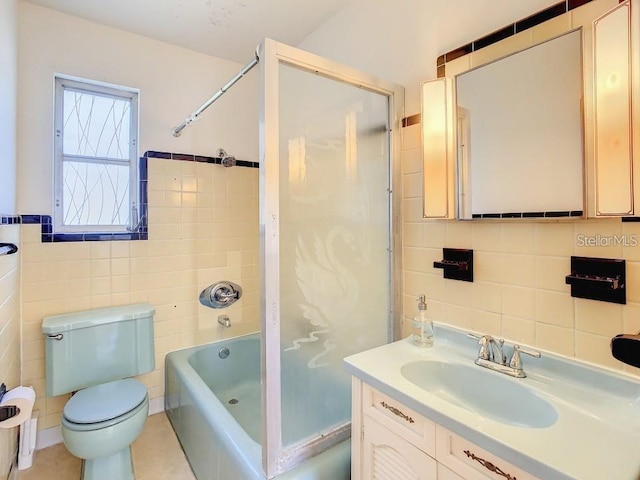 full bathroom with toilet,  shower combination, tile walls, and vanity