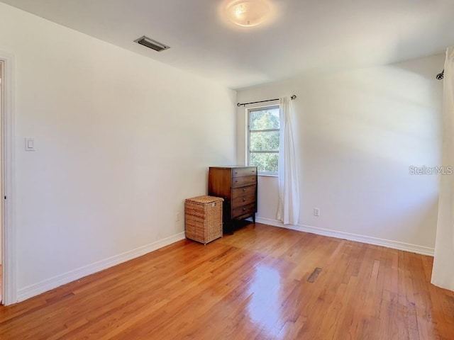 spare room featuring light hardwood / wood-style floors