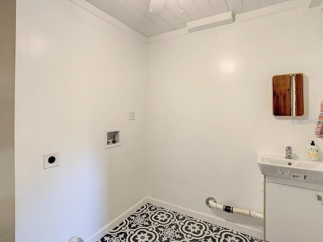 washroom featuring crown molding, tile patterned floors, sink, hookup for a washing machine, and hookup for an electric dryer