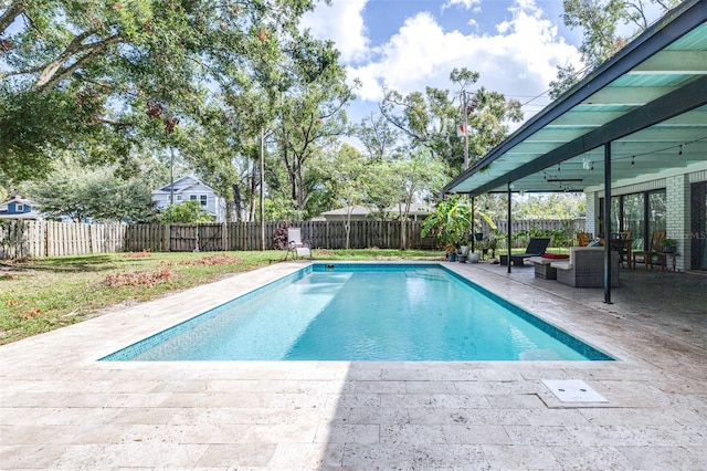 view of swimming pool with an outdoor living space and a patio