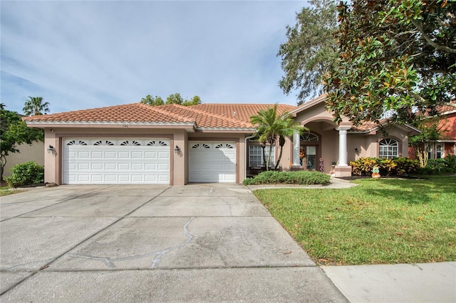 view of front of home with a garage and a front lawn