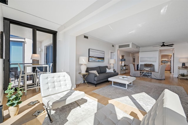 living room with light wood-type flooring and ceiling fan