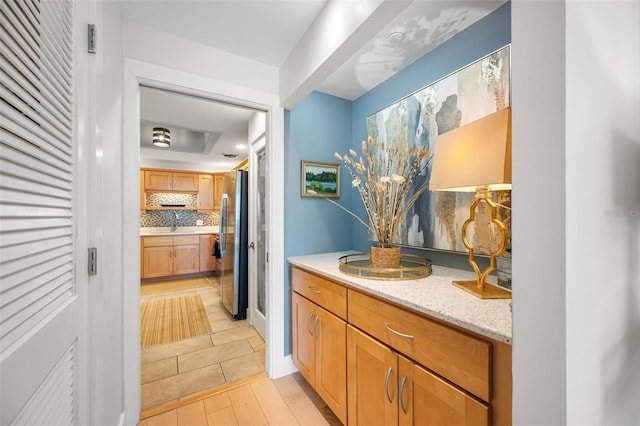 hallway with light hardwood / wood-style floors