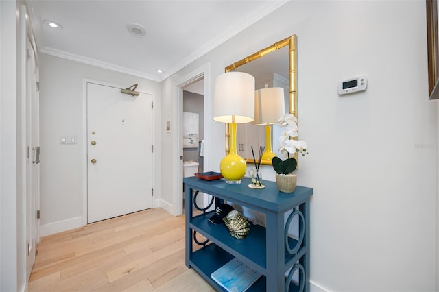 entrance foyer featuring light hardwood / wood-style floors and ornamental molding